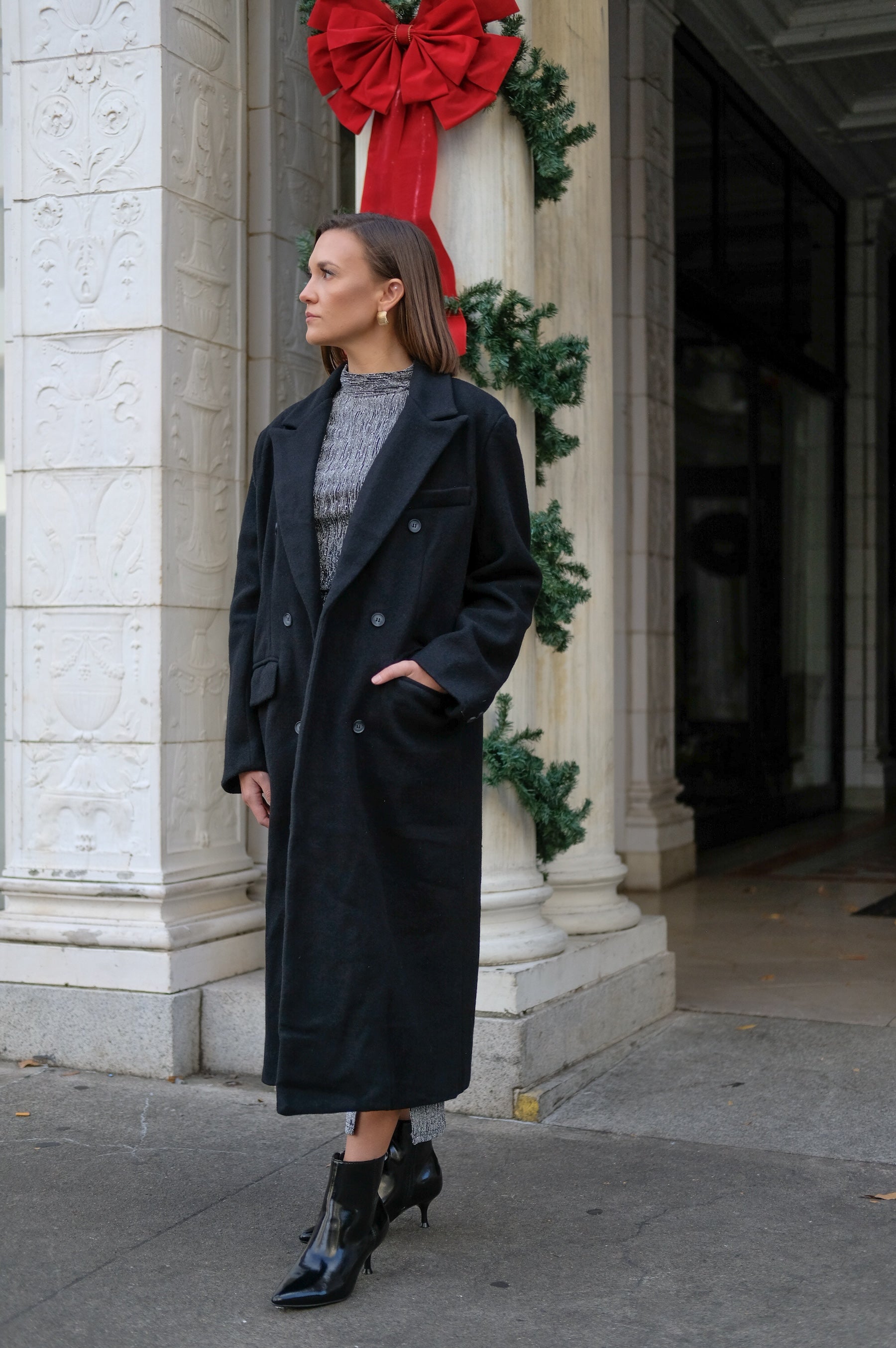 Long black coat, classic staple, knit fabric; double breasted button front with pockets