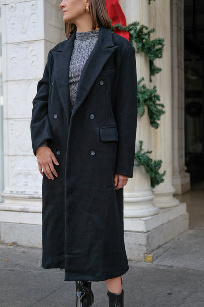 Long black coat, classic staple, knit fabric; double breasted button front with pockets