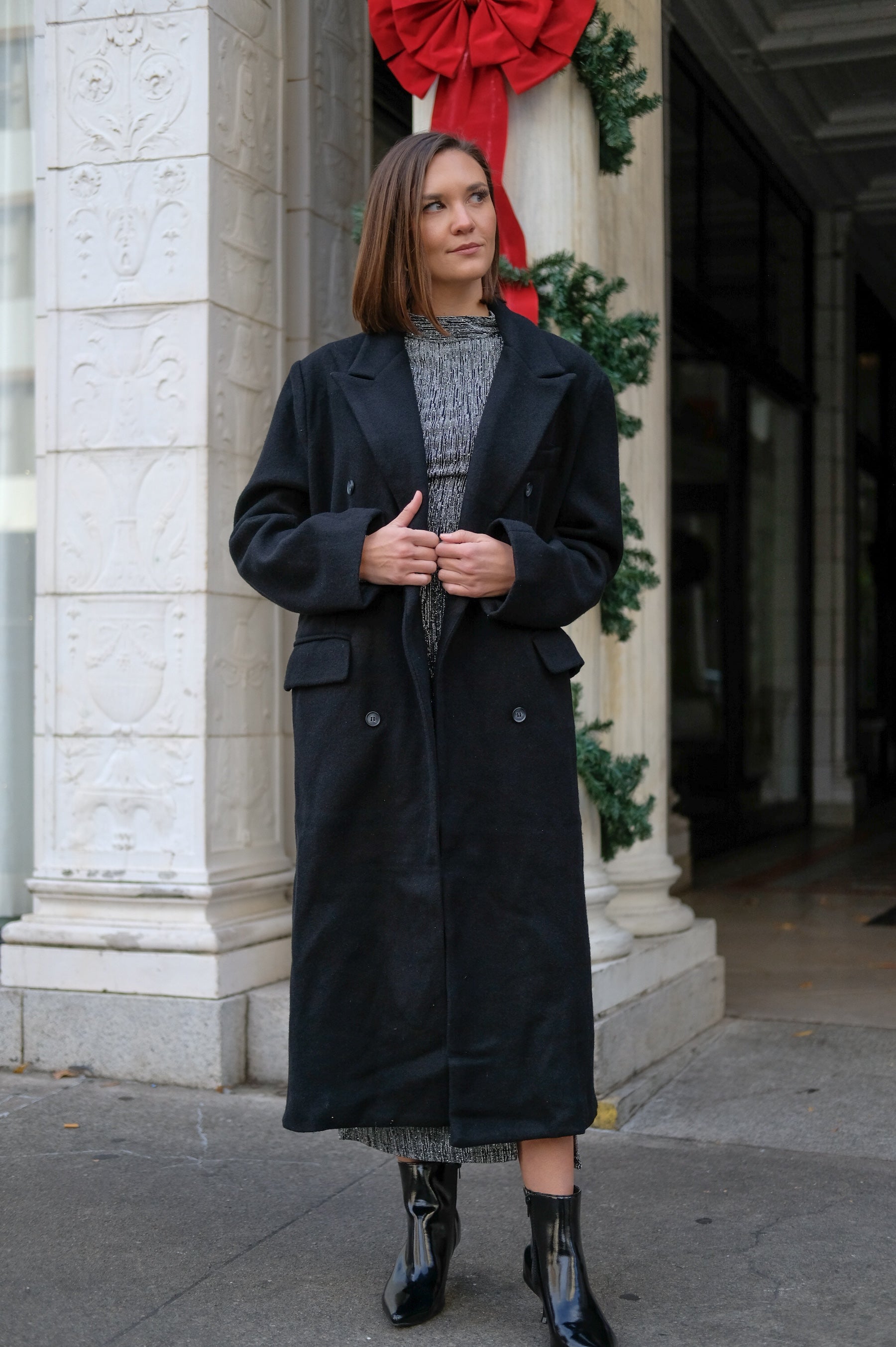 Long black coat, classic staple, knit fabric; double breasted button front with pockets